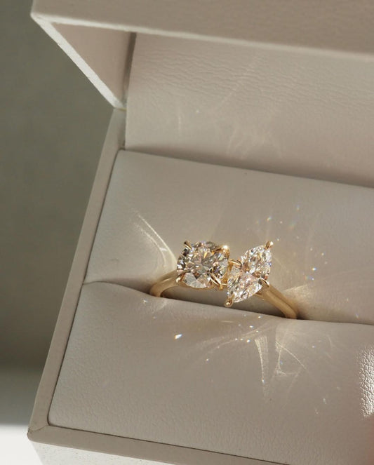 1ct Round And Marquise Toi Et Moi Cut Diamond Ring The hand displays a soft, natural manicure, highlighting the diamond's brilliance and the ring's refined craftsmanship. Ideal for those seeking timeless, high-end accessories for special occasions. YouTube Amazon Facebook Weather Google Gmail Wordless WhatsApp Web Translate News blog post ring ceremony Article Life Money 2025 design Ring Ceremony Diamond Shape Diamond Ring Surat Diamond India Market Diamond Ring for Her Diamond Ring for Men Diamond Ring