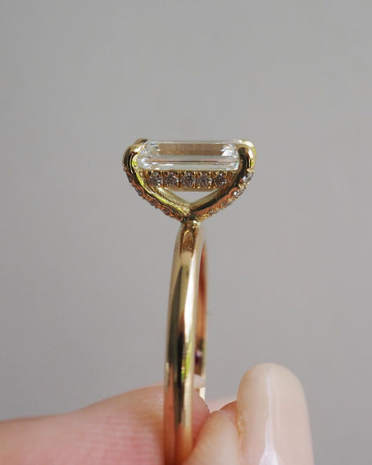 5.5ct Emerald Hidden Halo Lab Grown Diamond Ring Close-up of a hand adorned with a sparkling diamond ring on a sleek gold band, featuring a modern and elegant design. The ring is perfect for engagement, wedding, or luxury jewelry collections. YouTube Amazon Facebook Weather Google Gmail Wordless WhatsApp Web Translate News blog post ring ceremony Article Life Money 2025 design Ring Ceremony Diamond Shape Diamond Ring Surat Diamond India Market Diamond Ring for Her Diamond Ring for Men Diamond Ring Women