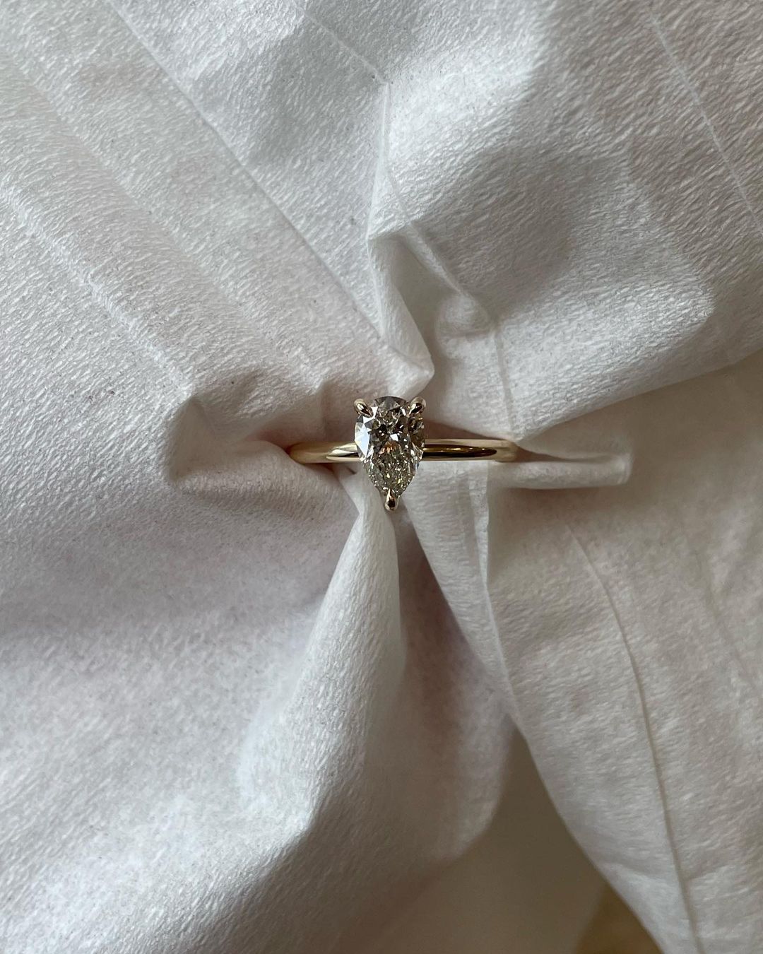 0.5ct Pear Three Claw Lab Grown Diamond Ring YouTube Amazon Facebook Weather Google Gmail Wordless WhatsApp Web Translate News blog post ring ceremony Article Life Money 2025 design Ring Ceremony Diamond Shape Diamond Ring Surat Diamond India Market Diamond Ring for Her Diamond Ring for Men Diamond Ring Women Engagement Ring Finger For Her Finger Ring Gold Ring Bluestone Ring Diamond Ring Price Gold Ring Price diamond engagement ring with a sleek gold band, featured on a hand with a minimalist manicure. 