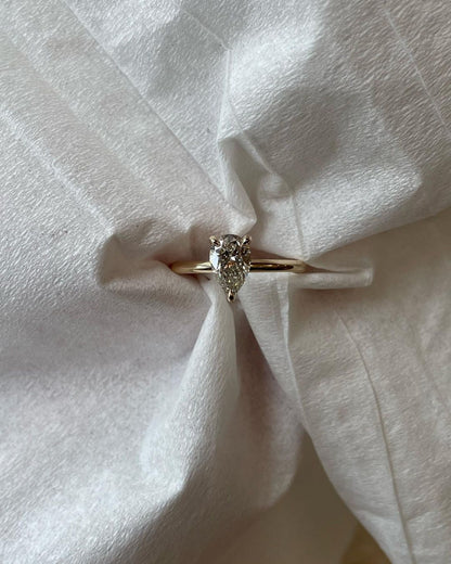 0.5ct Pear Three Claw Lab Grown Diamond Ring YouTube Amazon Facebook Weather Google Gmail Wordless WhatsApp Web Translate News blog post ring ceremony Article Life Money 2025 design Ring Ceremony Diamond Shape Diamond Ring Surat Diamond India Market Diamond Ring for Her Diamond Ring for Men Diamond Ring Women Engagement Ring Finger For Her Finger Ring Gold Ring Bluestone Ring Diamond Ring Price Gold Ring Price diamond engagement ring with a sleek gold band, featured on a hand with a minimalist manicure. 