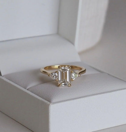 1.5ct Emerald Cut Center Stone With Two Trillion Cut Side Stone Lab Grown Diamond Ring Engagement Ring For Her and Wedding Ring For Women
Elegant close-up of a hand showcasing an engagement ring with a gold band, ideal for proposals, weddings, or luxury jewelry collections, paired with a soft, natural manicure google instagram YouTube Pinterest Post 