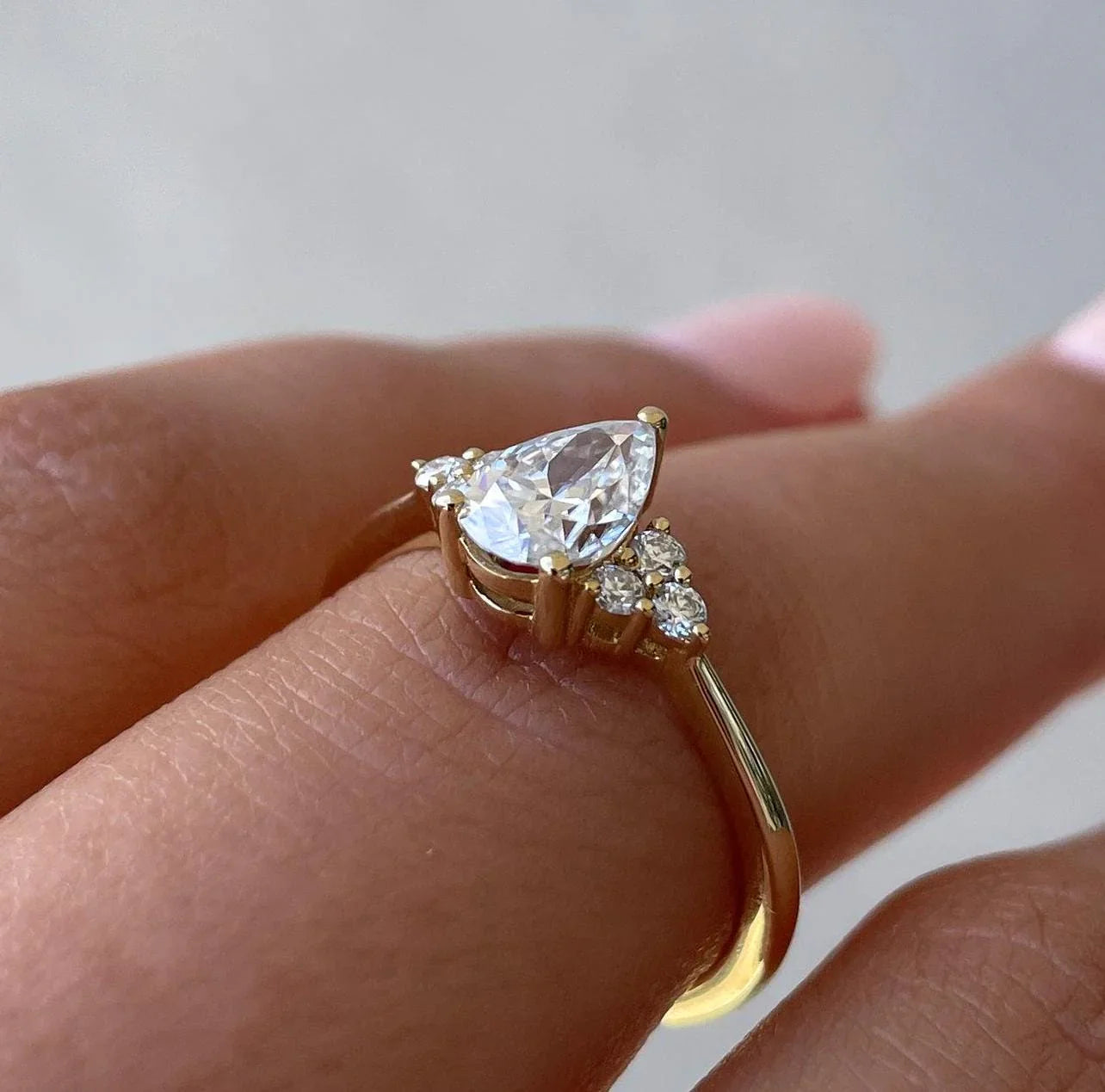 Elegant 1.30TCW pear shaped lab grown diamond ring with 3-claw setting and accent stones, IGI certified engagement jewelry design