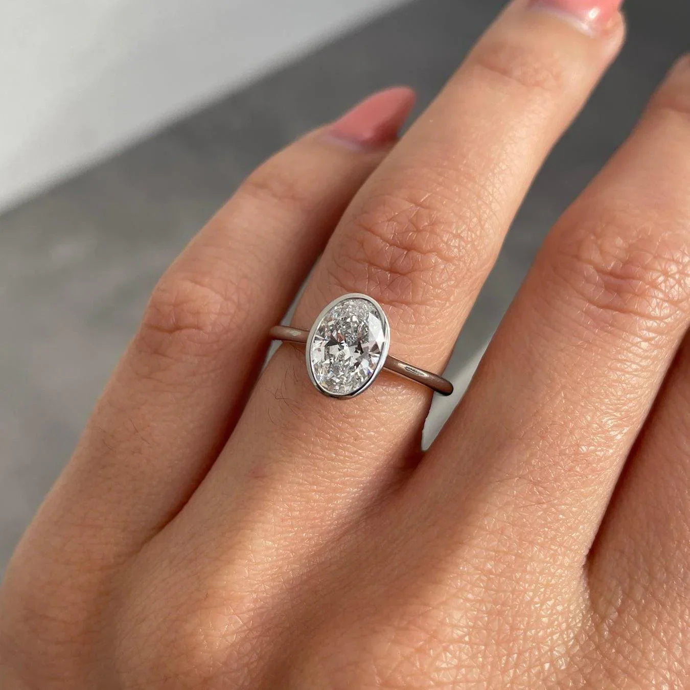 1.50ct oval lab grown diamond engagement ring, bezel setting, IGI certified bridal jewelry, modern wedding ring for women, ethical diamond ring