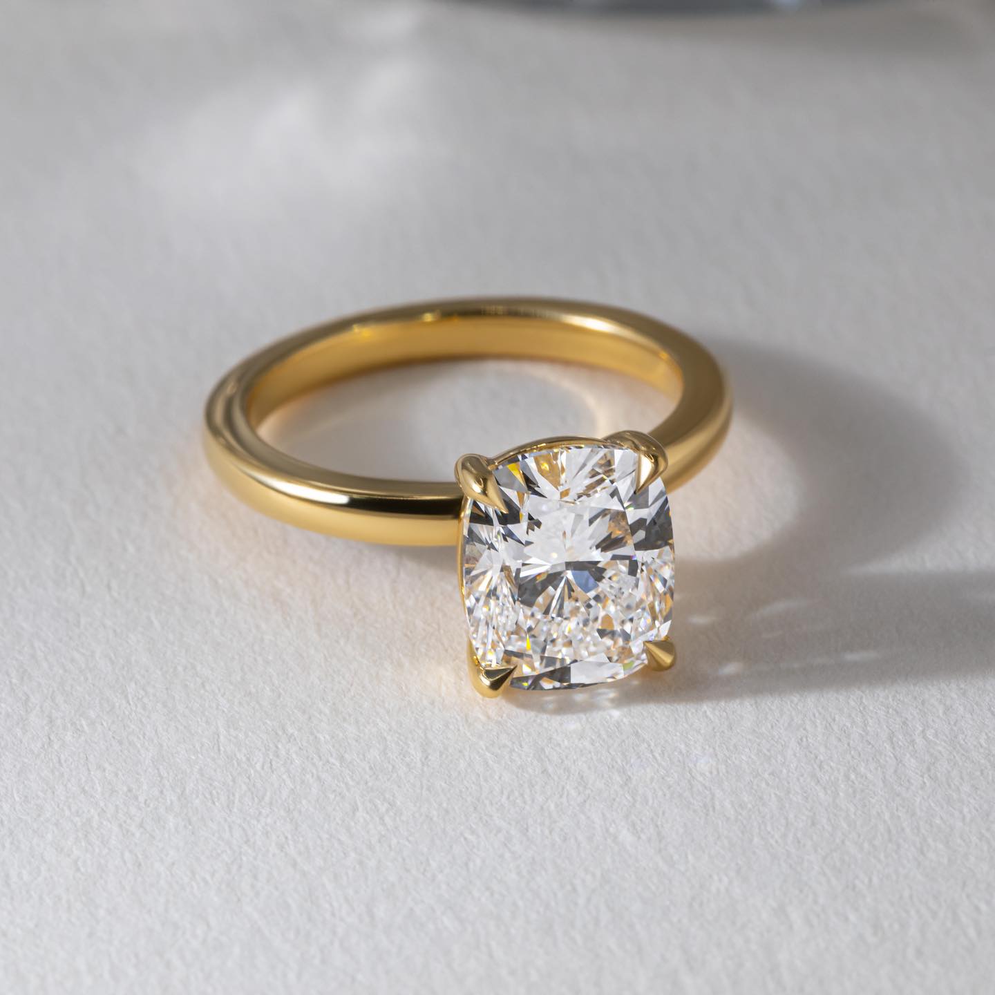 1ct Cushion Cut Lab Grown Diamond Ring Elegant close-up of a hand showcasing an engagement ring with a gold band, ideal for proposals, weddings, or luxury jewelry collections, paired with a soft, natural manicure. YouTube Amazon Facebook Weather Google Gmail Wordless WhatsApp Web Translate News blog post ring ceremony Article Life Money 2025 design Ring Ceremony Diamond Shape Diamond Ring Surat Diamond India Market Diamond Ring for Her Diamond Ring for Men Diamond Ring Women Engagement Ring Finger For Her 