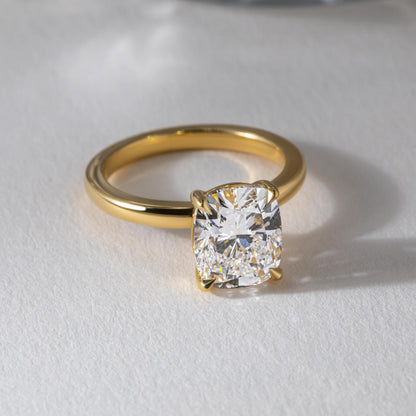 1ct Cushion Cut Lab Grown Diamond Ring Elegant close-up of a hand showcasing an engagement ring with a gold band, ideal for proposals, weddings, or luxury jewelry collections, paired with a soft, natural manicure. YouTube Amazon Facebook Weather Google Gmail Wordless WhatsApp Web Translate News blog post ring ceremony Article Life Money 2025 design Ring Ceremony Diamond Shape Diamond Ring Surat Diamond India Market Diamond Ring for Her Diamond Ring for Men Diamond Ring Women Engagement Ring Finger For Her 