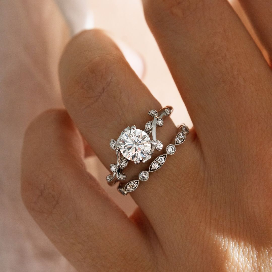 1ct Round Cut Lab Grown With Vine Band Ring Close-up of an exquisite gold-band ring featuring a diamond, ideal for engagement celebrations or luxury jewelry enthusiasts. The soft manicure enhances the refined and elegant appeal. YouTube Amazon Facebook Weather Google Gmail Wordless WhatsApp Web Translate News blog post ring ceremony Article Life Money 2025 design Ring Ceremony Diamond Shape Diamond Ring Surat Diamond India Market Diamond Ring for Her Diamond Ring for Men Diamond Ring Women Engagement Ring 