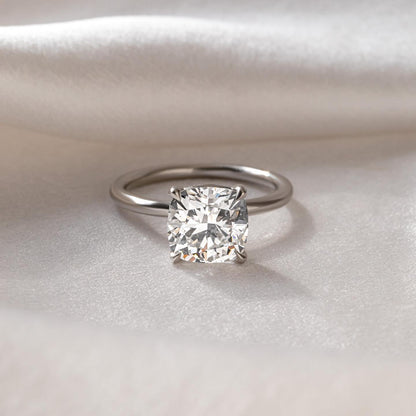 1ct Cushion Cut Lab Grown Diamond Ring Elegant close-up of a hand showcasing an engagement ring with a gold band, ideal for proposals, weddings, or luxury jewelry collections, paired with a soft, natural manicure. YouTube Amazon Facebook Weather Google Gmail Wordless WhatsApp Web Translate News blog post ring ceremony Article Life Money 2025 design Ring Ceremony Diamond Shape Diamond Ring Surat Diamond India Market Diamond Ring for Her Diamond Ring for Men Diamond Ring Women Engagement Ring Finger For Her 