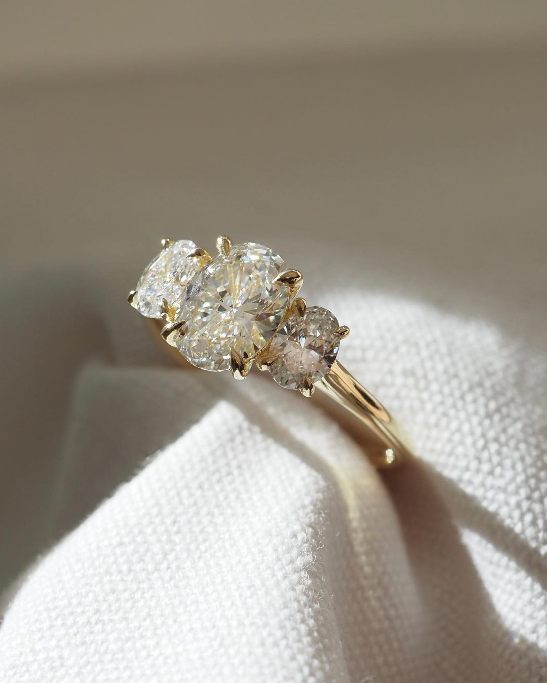 2.5ct Trio Oval Cut Lab Grown Diamond Ring  The hand displays a soft, natural manicure, highlighting the diamond's brilliance and the ring's refined craftsmanship. Ideal for those seeking timeless, high-end accessories for special occasions. Luxurious diamond Ring, Wedding Ring, Anniversary and Promise Ring For Her