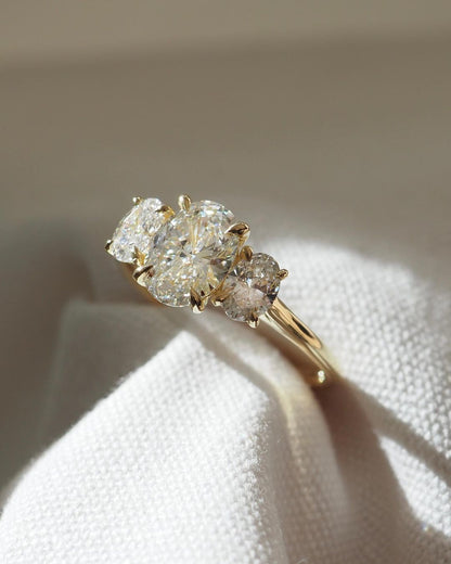 2.5ct Trio Oval Cut Lab Grown Diamond Ring  The hand displays a soft, natural manicure, highlighting the diamond's brilliance and the ring's refined craftsmanship. Ideal for those seeking timeless, high-end accessories for special occasions. Luxurious diamond Ring, Wedding Ring, Anniversary and Promise Ring For Her