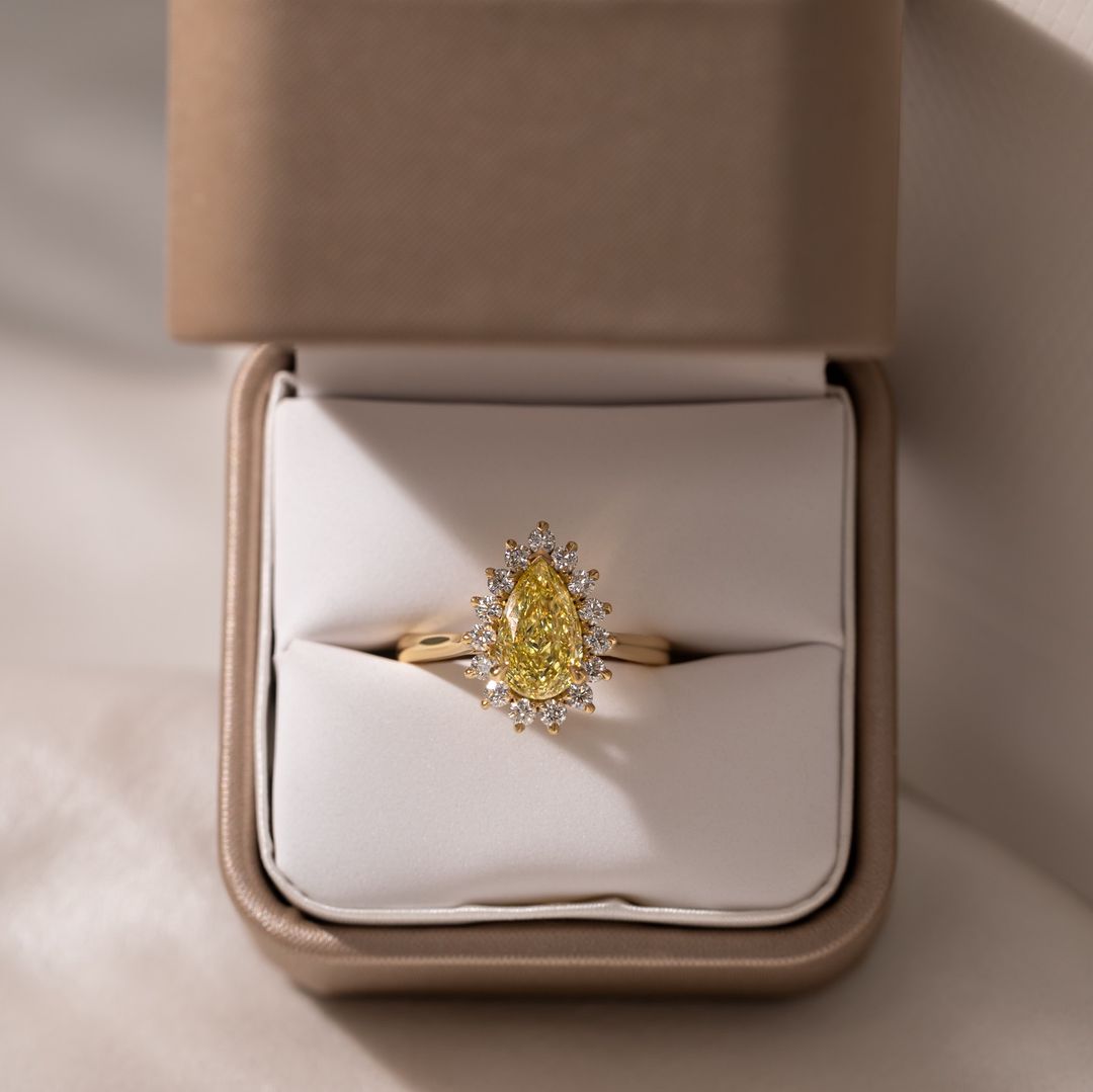 2ct Pear Cut Center stone with Princess cut Crown Lab Grown Diamond Ring  The hand displays a soft, natural manicure, highlighting the diamond's brilliance and the ring's refined craftsmanship. Ideal for those seeking timeless, high-end accessories for special occasions. YouTube Amazon Facebook Weather Google Gmail Wordless WhatsApp Web Translate News blog post ring ceremony Article Life Money 2025 design Ring Ceremony Diamond Shape Diamond Ring Surat Diamond India Market Diamond Ring for Her Diamond Ring 