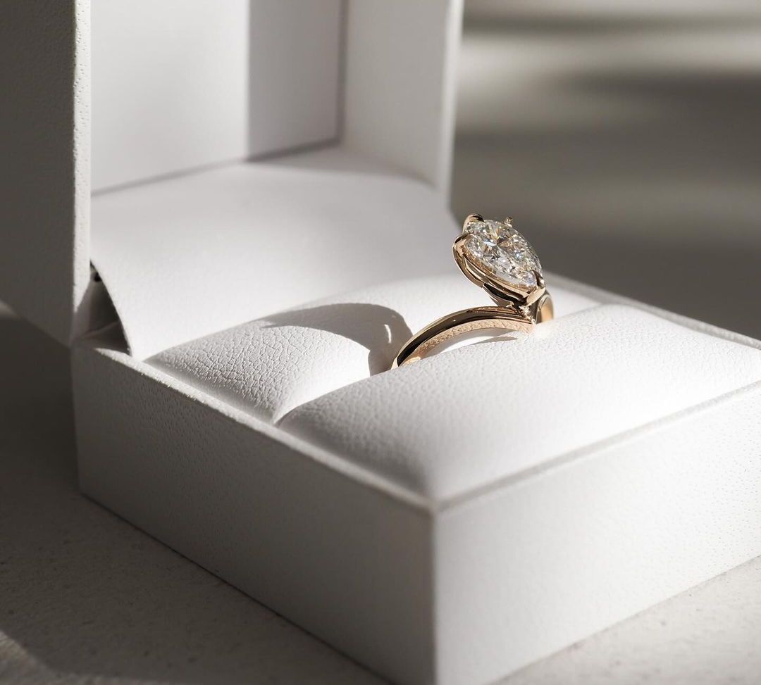 2ct Pear Cut Lab Grown Diamond Solitaire Ring Luxurious diamondWeb Translate News blog post ring ceremony Article Life Money 2025 design Ring Ceremony Diamond Shape Diamond Ring Surat Diamond India Market Diamond Ring for Her Diamond Ring for Men Diamond Ring Women Engagement Ring Finger For Her Finger Ring Gold Ring Bluestone Ring Diamond Ring Price Gold Ring Price Close-up of an exquisite gold-band ring featuring a diamond, ideal for engagement celebrations or luxury jewelry enthusiasts. The soft manicure
