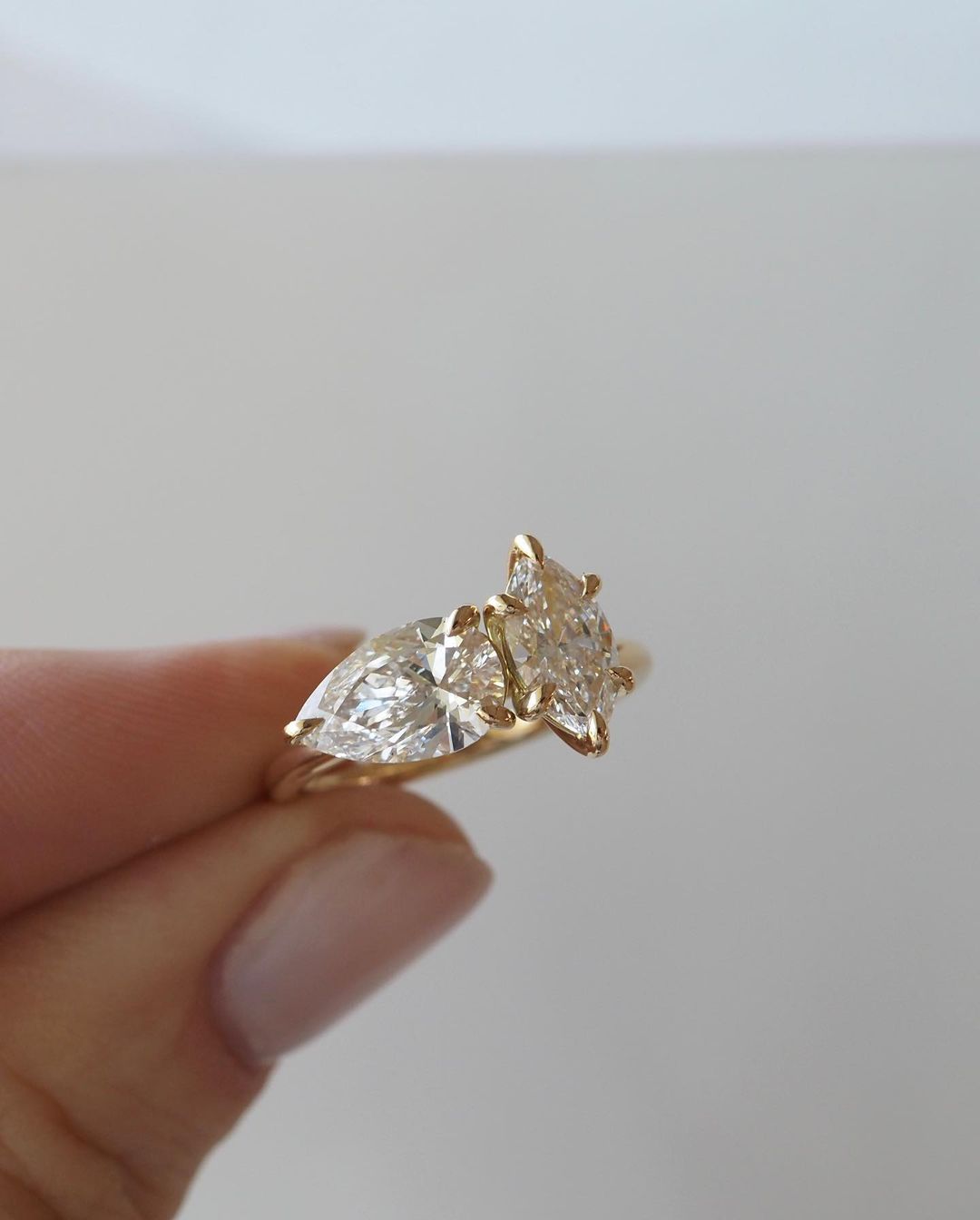 2tcw Marquise & Pear Cut Bespoke Toi Et Moi Lab Grown Diamond Ring Elegant close-up of a hand showcasing an engagement ring with a gold band, ideal for proposals, weddings, or luxury jewelry collections, paired with a soft, natural manicure. YouTube Amazon Facebook Weather Google Gmail Wordless WhatsApp Web Translate News blog post ring ceremony Article Life Money 2025 design Ring Ceremony Diamond Shape Diamond Ring Surat Diamond India Market Diamond Ring for Her Diamond Ring for Men Diamond Ring Women 