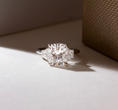 3.5ct Cushion Cut Trapezoid Lab Grown Diamond Ring  The hand displays a soft, natural manicure, highlighting the diamond's brilliance and the ring's refined craftsmanship. Ideal for those seeking timeless, high-end accessories for special occasions. YouTube Amazon Facebook Weather Google Gmail Wordless WhatsApp Web Translate News blog post ring ceremony Article Life Money 2025 design Ring Ceremony Diamond Shape Diamond Ring Surat Diamond India Market Diamond Ring for Her Diamond Ring for Men Diamond Ring 