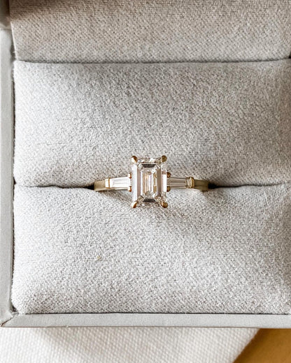 3ct Emerald Center Stone With Two Side Stone Lab Grown Diamond Ring  The hand displays a soft, natural manicure, highlighting the diamond's brilliance and the ring's refined craftsmanship. Ideal for those seeking timeless, high-end accessories for special occasions. YouTube Amazon Facebook Weather Google Gmail Wordless WhatsApp Web Translate News blog post ring ceremony Article Life Money 2025 design Ring Ceremony Diamond Shape Diamond Ring Surat Diamond India Market Diamond Ring for Her Diamond Ring for 