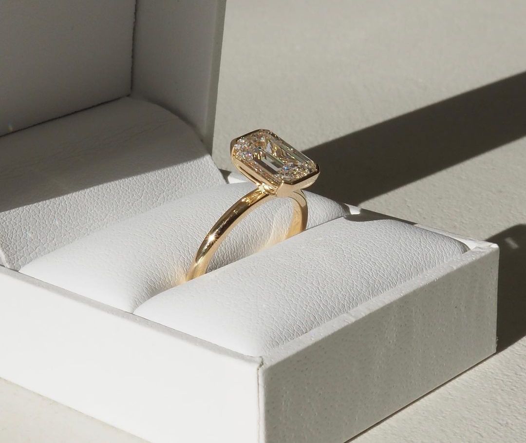 3ct Emerald Half Bezel Lab Grown Diamond Ring Modern  diamond solitaire ring on a gold band, styled with a natural manicure. A perfect symbol of love for engagements, proposals, weddings, or premium jewelry collections. YouTube Amazon Facebook Weather Google Gmail Wordless WhatsApp Web Translate News blog post ring ceremony Article Life Money 2025 design Ring Ceremony Diamond Shape Diamond Ring Surat Diamond India Market Diamond Ring for Her Diamond Ring for Men Diamond Ring Women Engagement Ring Finger 