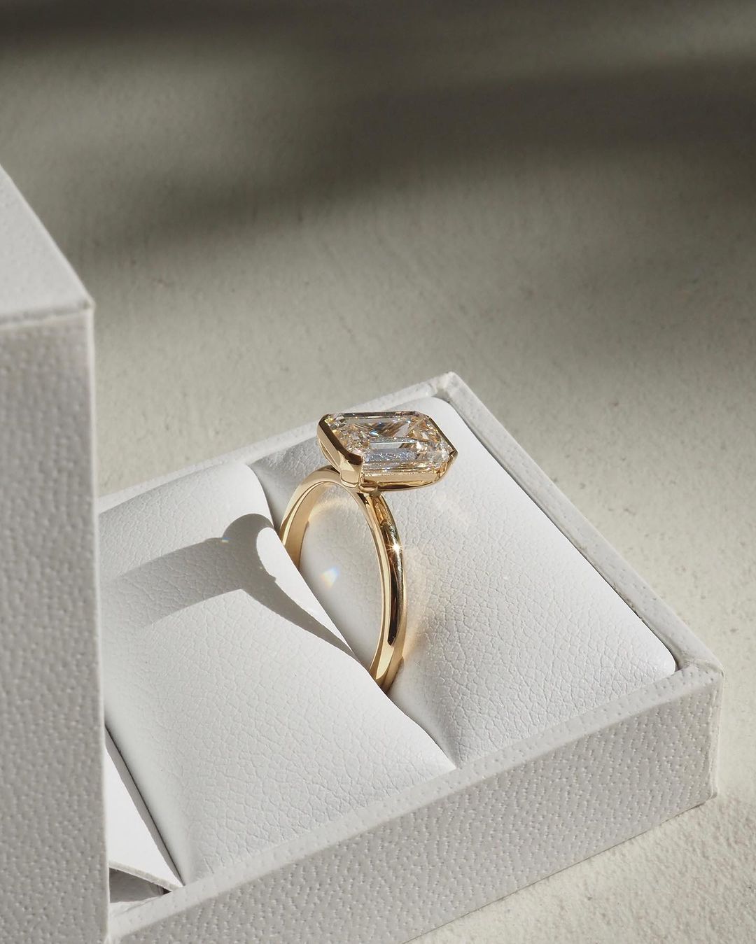 3ct Emerald Half Bezel Lab Grown Diamond Ring Close-up of an exquisite gold-band ring featuring a diamond, ideal for engagement celebrations or luxury jewelry enthusiasts. The soft manicure enhances the refined and elegant appeal. YouTube Amazon Facebook Weather Google Gmail Wordless WhatsApp Web Translate News blog post ring ceremony Article Life Money 2025 design Ring Ceremony Diamond Shape Diamond Ring Surat Diamond India Market Diamond Ring for Her Diamond Ring for Men Diamond Ring Women Engagement Ring