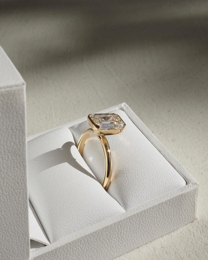 3ct Emerald Half Bezel Lab Grown Diamond Ring Close-up of an exquisite gold-band ring featuring a diamond, ideal for engagement celebrations or luxury jewelry enthusiasts. The soft manicure enhances the refined and elegant appeal. YouTube Amazon Facebook Weather Google Gmail Wordless WhatsApp Web Translate News blog post ring ceremony Article Life Money 2025 design Ring Ceremony Diamond Shape Diamond Ring Surat Diamond India Market Diamond Ring for Her Diamond Ring for Men Diamond Ring Women Engagement Ring