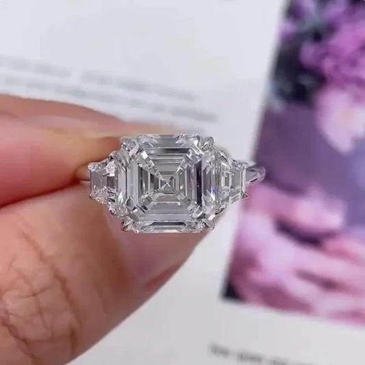 5.0ct Asscher lab grown diamond engagement ring, trapezoid side stones, three stone design, IGI certified bridal jewelry