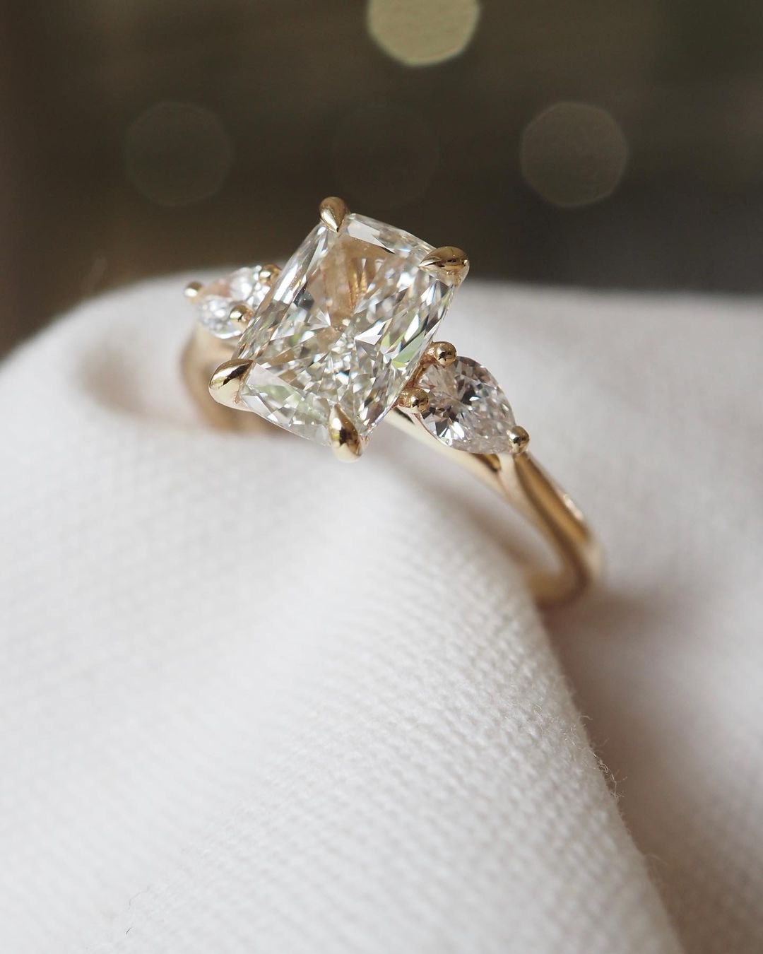 4ct Cushion Cut Center Diamond With Two Side Pear Cut Lab Grown Diamond Ring Close-up of an exquisite gold-band ring featuring a diamond, ideal for engagement celebrations or luxury jewelry enthusiasts. The soft manicure enhances the refined and elegant appeal. YouTube Amazon Facebook Weather Google Gmail Wordless WhatsApp Web Translate News blog post ring ceremony Article Life Money 2025 design Ring Ceremony Diamond Shape Diamond Ring Surat Diamond India Market Diamond Ring for Her Diamond Ring for Men 