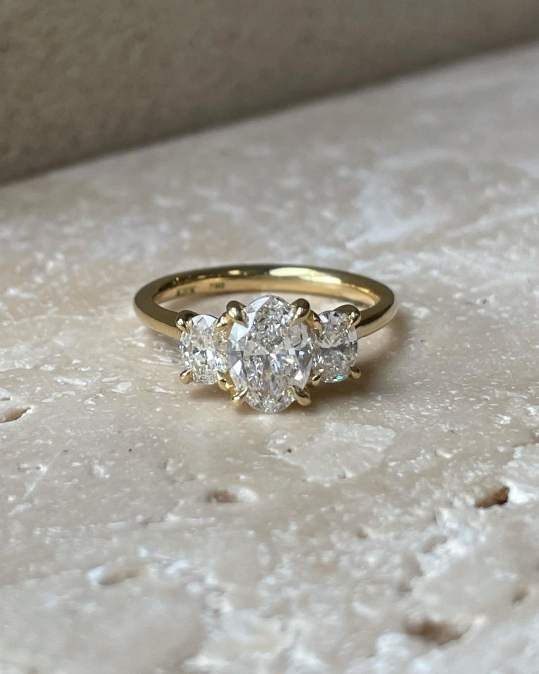 1.5ct Oval Trio Lab Grown Diamond Ring wedding Set Three Stone  Close-up of an exquisite gold-band ring featuring a diamond, ideal for engagement celebrations or luxury jewelry enthusiasts. The soft manicure enhances the refined and elegant appeal. YouTube Amazon Facebook Weather Google Gmail Wordless WhatsApp Web Translate News blog post ring ceremony Article Life Money 2025 design Ring Ceremony Diamond Shape Diamond Ring Surat Diamond India Market Diamond Ring for Her Diamond Ring for Men Diamond Ring 