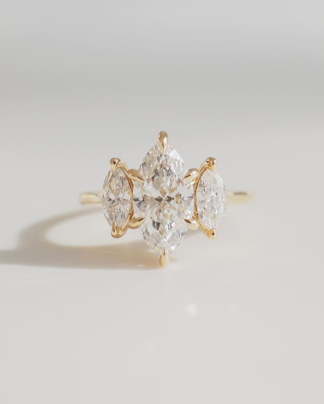 4tcw Marquise Three Lab Grown Diamond Ring Elegant close-up of a hand showcasing an engagement ring with a gold band, ideal for proposals, weddings, or luxury jewelry collections, paired with a soft, natural manicure. YouTube Amazon Facebook Weather Google Gmail Wordless WhatsApp Web Translate News blog post ring ceremony Article Life Money 2025 design Ring Ceremony Diamond Shape Diamond Ring Surat Diamond India Market Diamond Ring for Her Diamond Ring for Men Diamond Ring Women Engagement Ring Finger For 