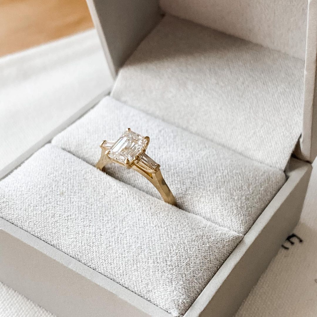 Emerald Center Stone With Two Side Baguette Stone Lab Grown Diamond Ring Exquisite gold engagement ring with a diamond, styled for luxury, weddings, and proposal inspiration photography. modern engagement rings, premium wedding bands, or high-end diamond rings.