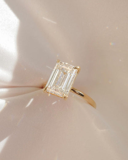 8ct Emerald Lab Grown Diamond Elegant close-up of a hand showcasing an engagement ring with a gold band, ideal for proposals, weddings, or luxury jewelry collections, paired with a soft, natural manicure. Ring  YouTube Amazon Facebook Weather Google Gmail Wordless WhatsApp Web Translate News blog post ring ceremony Article Life Money 2025 design Ring Ceremony Diamond Shape Diamond Ring Surat Diamond India Market Diamond Ring for Her Diamond Ring for Men Diamond Ring Women Engagement Ring Finger For Her 