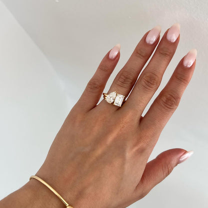 3ct Pear & Emerald Toi Et Moi Lab Grown Diamond Ring Close-up of an exquisite gold-band ring featuring a diamond, ideal for engagement celebrations or luxury jewelry enthusiasts. The soft manicure enhances the refined and elegant appeal. YouTube Amazon Facebook Weather Google Gmail Wordless WhatsApp Web Translate News blog post ring ceremony Article Life Money 2025 design  