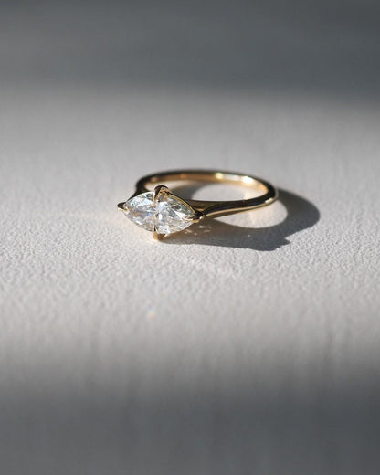 1.5ct Marquise Solitaire Lab Grown Diamond Ring Close-up of an exquisite gold-band ring featuring a diamond, ideal for engagement celebrations or luxury jewelry enthusiasts. The soft manicure enhances the refined and elegant appeal. Women Engagement Ring Finger For Her Finger Ring Gold Ring Bluestone Ring Diamond Ring Price Gold Ring Price