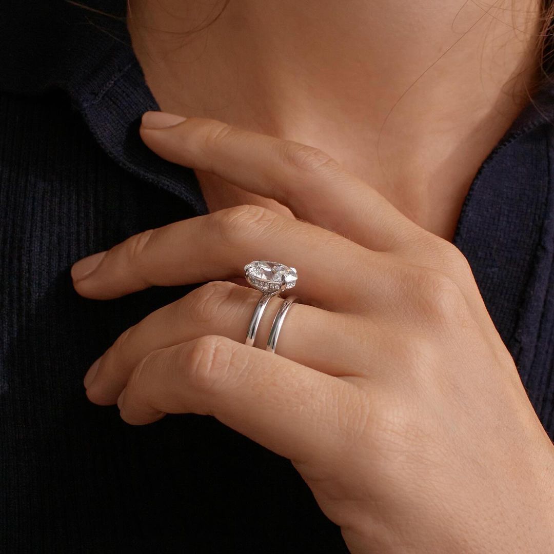 2.5ct Oval Cut With Hidden Halo Eliana Setting Pave Band Lab Grown Diamond Ring Elegant close-up of a hand showcasing an engagement ring with a gold band, ideal for proposals, weddings, or luxury jewelry collections, paired with a soft, natural manicure. YouTube Amazon Facebook Weather Google Gmail Wordless WhatsApp Web Translate News blog post ring ceremony Article Life Money 2025 design Ring Ceremony Diamond Shape Diamond Ring Surat Diamond India Market Diamond Ring for Her Diamond Ring for Men Diamond 