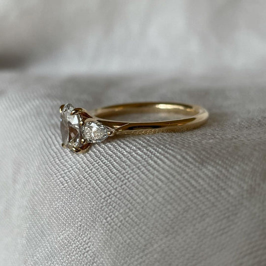 1.2ct Oval Lab Grown Diamond With Shoulder Stone Ring Minimalist Engagement Ring and wedding gift or Birthday Gift her/women Radiant gold-banded diamond engagement ring with a, displayed on a hand with a chic manicure for bridal and luxury jewelry lovers. modern engagement rings, premium wedding bands, or high-end diamond rings.