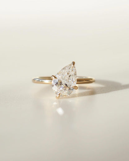 2.5ct Pear Cut Diamond Solitaire Lab Grown Diamond Ring  Exquisite diamond-studded gold ring with a modern and elegant design. Luxury gold ring with sparkling diamonds, perfect for weddings or special occasions. YouTube Amazon Facebook Weather Google Gmail Wordless WhatsApp Web Translate News blog post ring ceremony Article Life Money 2025 design Ring Ceremony Diamond Shape Diamond Ring Surat Diamond India Market Diamond Ring for Her Diamond Ring for Men Diamond Ring Women Engagement Ring Finger For Her 