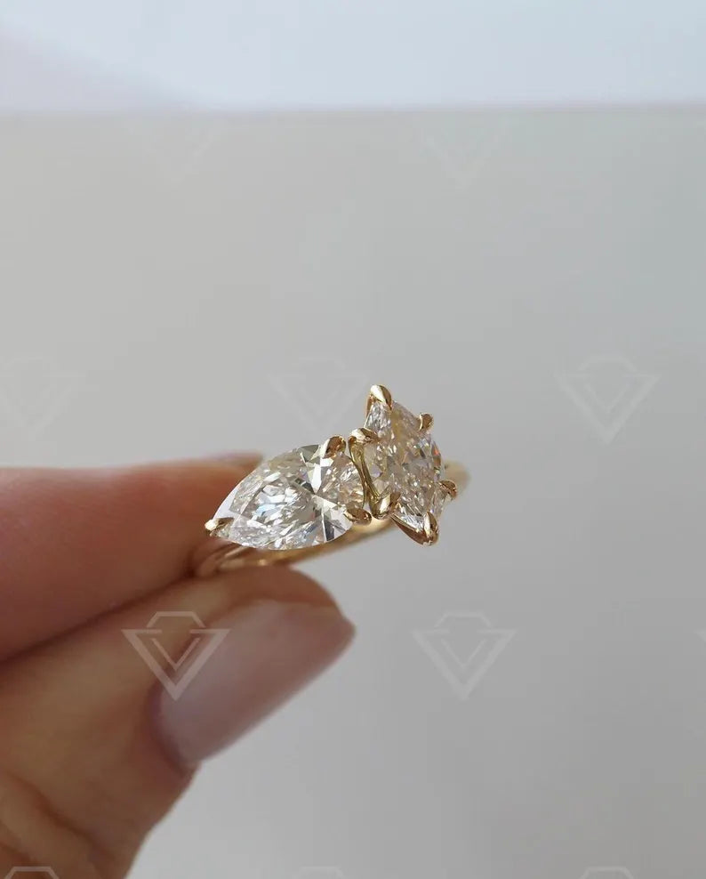 2.10tcw marquise and pear-shaped lab-grown diamond ring with a unique Toi et Moi setting, ideal for a meaningful and sustainable wedding or promise ring.